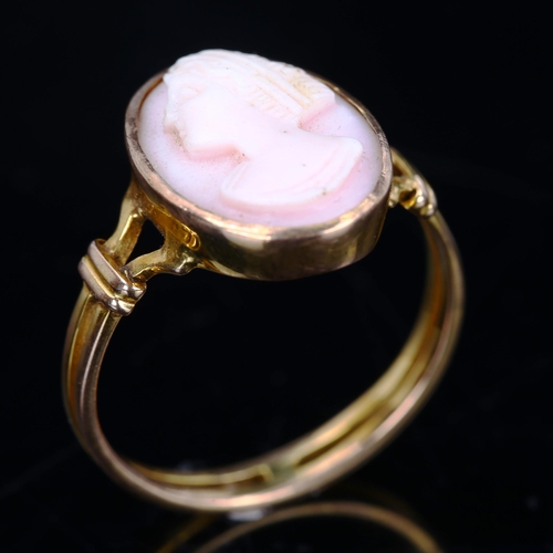 205 - An unmarked gold relief carved pink coral cameo ring, depicting female profile, setting height 16mm,... 