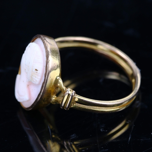 205 - An unmarked gold relief carved pink coral cameo ring, depicting female profile, setting height 16mm,... 