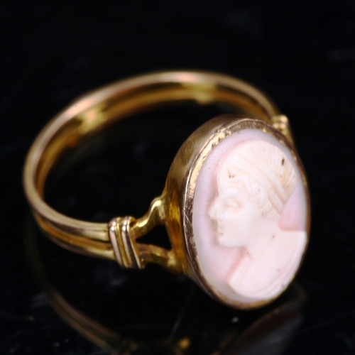 205 - An unmarked gold relief carved pink coral cameo ring, depicting female profile, setting height 16mm,... 