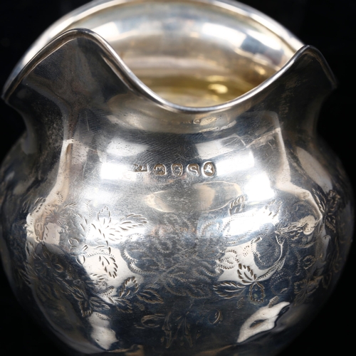 212 - A George III silver cream jug, bright-cut engraved floral decoration with gilt interior and bun feet... 