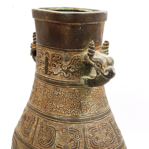 1006 - A Chinese Archaic style bronze vase, with relief decoration and dragon handles, height 30cm