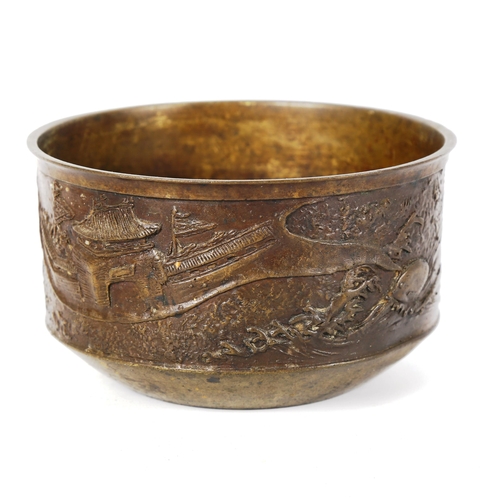 1012 - A Chinese bronze jardiniere, with relief moulded surround depicting palace buildings, seal mark unde... 