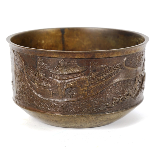 1012 - A Chinese bronze jardiniere, with relief moulded surround depicting palace buildings, seal mark unde... 