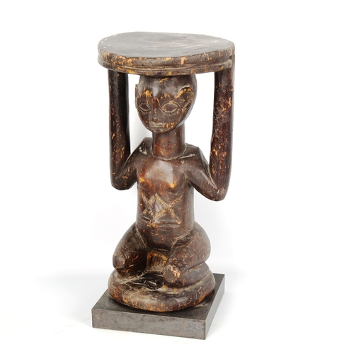 1022 - African Tribal carved wood stool in the form of a crouching figure, height 34cm