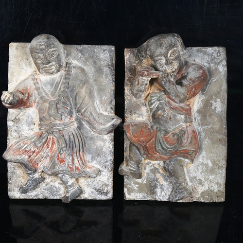 1029 - A pair of Chinese terracotta plaques, with dancing musician figures in high relief, height 28cm