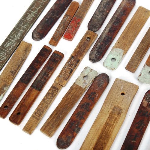 1055 - A Chinese engraved bronze rule, and a collection of Chinese wood tokens