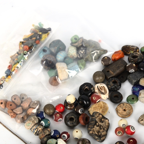 1056 - ANTIQUITIES - a collection of early ceramic and glass beads