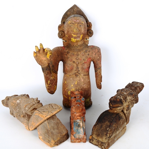 1083 - An Indian 19th century carved and painted wood wall-hanging figure, height 40cm, and 3 carved wood h... 