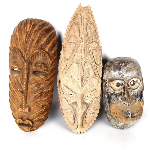 1086 - 3 carved wood Tribal masks, largest length 47cm