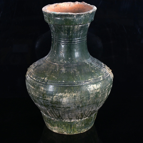 1105 - A large Chinese green glaze terracotta vase, with relief moulded mask handles, height 37cm