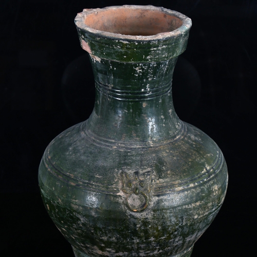 1105 - A large Chinese green glaze terracotta vase, with relief moulded mask handles, height 37cm