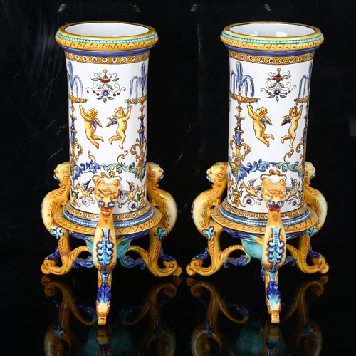 1123 - A pair of Italian faience pottery cylindrical vases, with hand painted Classical designs, on griffon... 