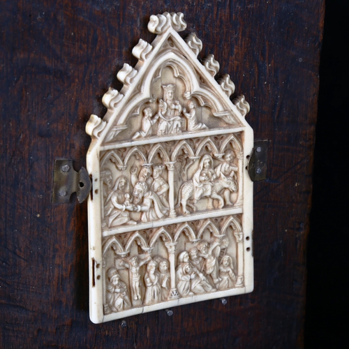 1124 - A relief carved ivory plaque, finely detailed carved panels depicting biblical scenes, height 10.5cm... 