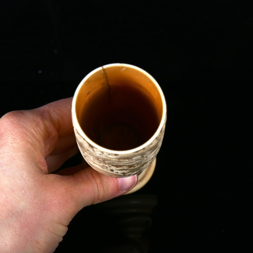 1134 - A Japanese ivory goblet circa 1900, the bowl relief carved with sea dragons, and ring turned base wi... 