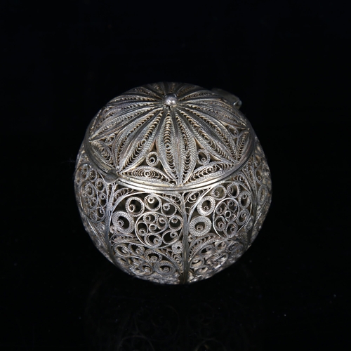 1136 - An unmarked Continental white metal filigree ball-shaped spice container, early 20th century, height... 