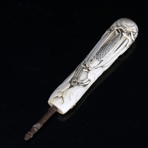 1138 - A Japanese relief carved ivory parasol handle, with carp and wave designs, length excluding screw fi... 