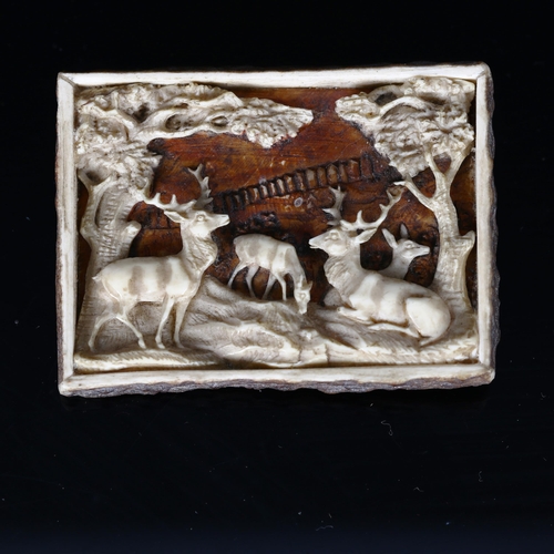 1144 - A 19th century Bavarian staghorn brooch, with relief carved design of stags in woodland, 6cm x 4.5cm