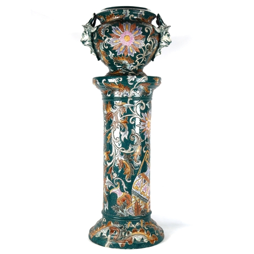 1153 - A Majolica pottery jardiniere on pedestal circa 1900, with grotesque mask handles and incised leaf d... 