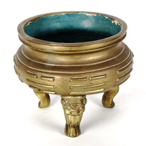 1158 - A Chinese bronze incense burner with raised bands resting on 3 masked decorated feet, impressed 6 ch... 