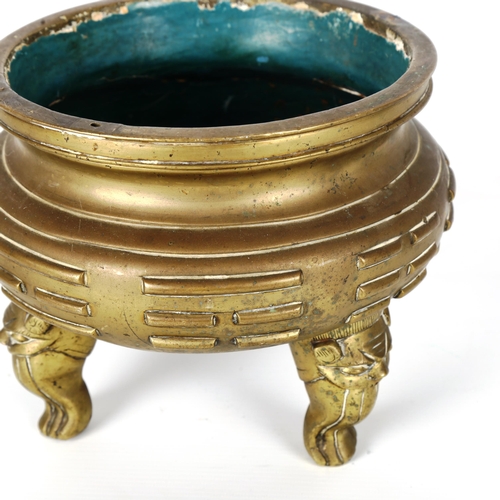 1158 - A Chinese bronze incense burner with raised bands resting on 3 masked decorated feet, impressed 6 ch... 