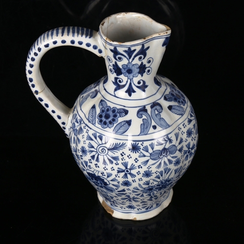 1163 - An Antique Delft tin-glaze pottery jug, 18th or 19th century, with hand painted decoration, signed u... 