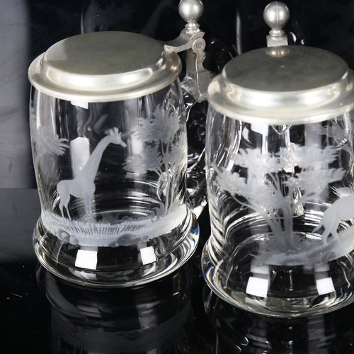 1166 - 4 Rowland Ward clear glass tankards with pewter lids, each engraved with a safari animal, thought to... 