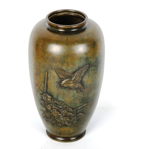 1176 - A Chinese patinated bronze vase, with relief moulded bird blossom design, height 21cm