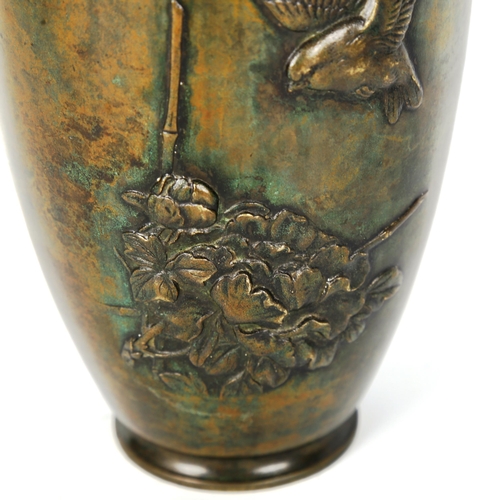 1176 - A Chinese patinated bronze vase, with relief moulded bird blossom design, height 21cm