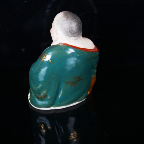 1210 - A Chinese porcelain seated Buddha, impressed marks under base, height 8cm