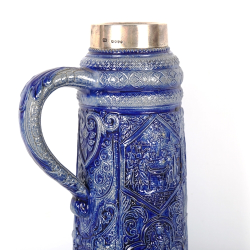 1222 - A 19th century blue glaze stoneware stein, with relief moulded panels and silver rim, hallmarks Lond... 