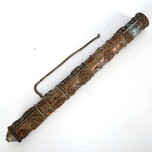 1224 - A Tibetan stone set copper scroll holder, with applied brass mounts, length 40cm