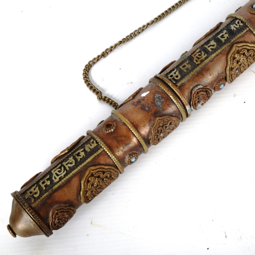 1224 - A Tibetan stone set copper scroll holder, with applied brass mounts, length 40cm