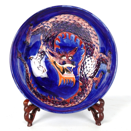 1235 - MOORCROFT POTTERY - a dragon design fruit bowl, diameter 26.5cm