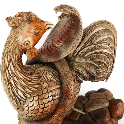 1262 - A carved and painted wood sculpture of a cobra and cockerel, height 43cm