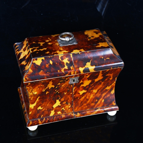 1295 - A 19th century tortoiseshell sarcophagus-shaped tea caddy, with ring handle, ivory ball feet and inn... 