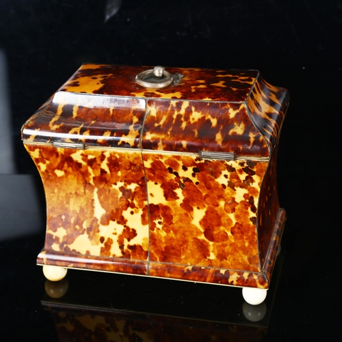 1295 - A 19th century tortoiseshell sarcophagus-shaped tea caddy, with ring handle, ivory ball feet and inn... 