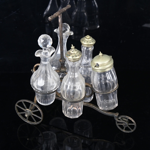 1302 - A Victorian novelty 5-bottle cruet set, modelled as a tricycle, original cut-glass bottles on electr... 