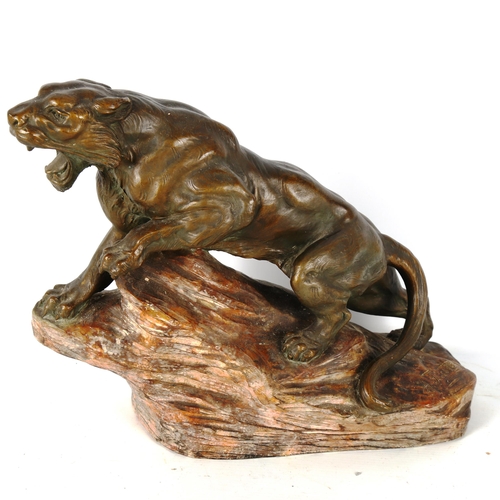 1308 - A bronze patinated pottery tiger on a rock, circa 1930, length approx 38cm, height 30cm