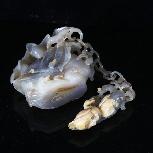 1312 - A Chinese lavender jade goose and goslings attached by a chain, carved from a single piece of stone,... 