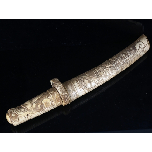 1314 - A Japanese bone dagger with relief carved decoration, early 20th century, length 37cm