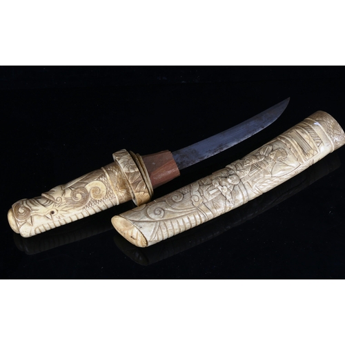 1314 - A Japanese bone dagger with relief carved decoration, early 20th century, length 37cm