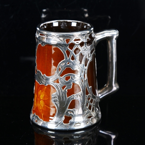 1317 - J B Owens, American Art Nouveau pottery mug with silver overlay decoration, impressed marks under ba... 