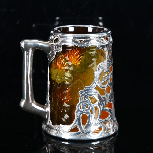 1317 - J B Owens, American Art Nouveau pottery mug with silver overlay decoration, impressed marks under ba... 