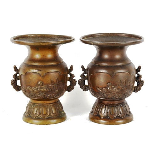 1321 - A pair of Chinese patinated bronze vases, with relief bird decorated panels and cast handles, height... 