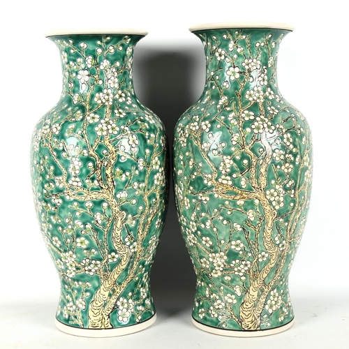 1322 - A pair of Chinese porcelain green ground vases, with blossom decoration, height 36cm