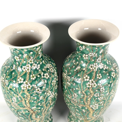 1322 - A pair of Chinese porcelain green ground vases, with blossom decoration, height 36cm