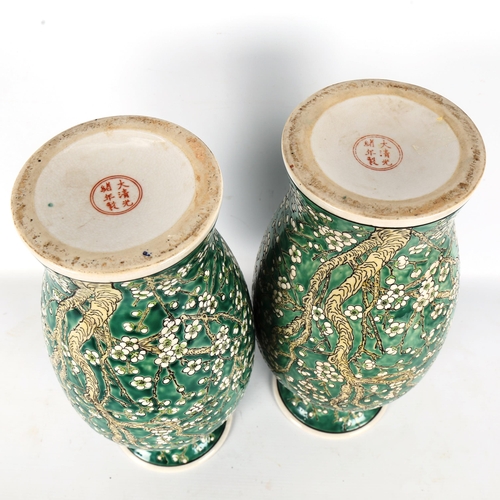 1322 - A pair of Chinese porcelain green ground vases, with blossom decoration, height 36cm