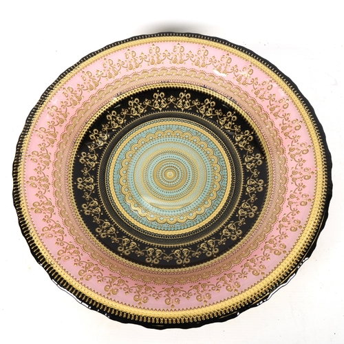 1325 - A Continental ceramic table centre bowl, with gilded decoration, diameter 40cm