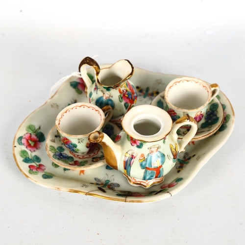 1328 - A Chinese famille rose porcelain doll's tea service on matching tray, tray length 14cm