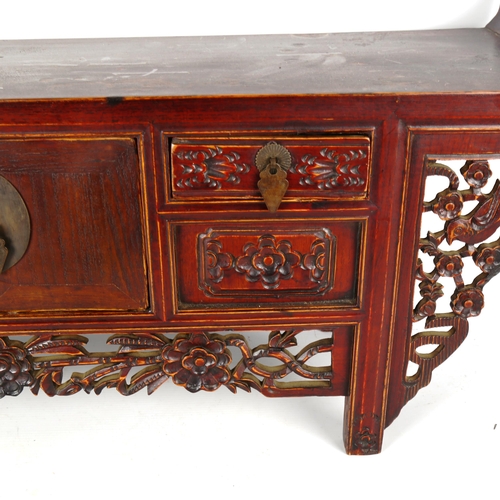 1329 - A Chinese stained wood altar table of small size, with 4 small carved drawers and central cupboard f... 